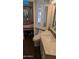 Bathroom with white cabinets, quartz counters, and mirrored cabinets next to bedroom at 2058 S Walla Walla Cir, Apache Junction, AZ 85119