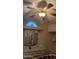 Bedroom featuring ceiling fan, a mirror, and view into the bathroom at 2058 S Walla Walla Cir, Apache Junction, AZ 85119