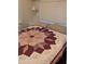 Comfortable bedroom with a decorative quilt and natural light from the window at 2058 S Walla Walla Cir, Apache Junction, AZ 85119