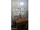 Cozy dining area with a wooden table, chairs, and a window view, perfect for meals at 2058 S Walla Walla Cir, Apache Junction, AZ 85119