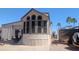 Manufactured home featuring an enclosed porch, desert landscaping, and carport on a paved lot at 2058 S Walla Walla Cir, Apache Junction, AZ 85119