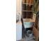 Close up of a laundry area with stacked washer and dryer, laundry sink, and storage shelves at 2058 S Walla Walla Cir, Apache Junction, AZ 85119