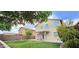 Spacious backyard featuring lush trees and a covered patio at 23217 N 22Nd Pl, Phoenix, AZ 85024
