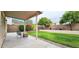 Green backyard with lush landscaping and covered patio area at 23217 N 22Nd Pl, Phoenix, AZ 85024