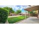 Lush backyard featuring green grass, mature trees, and a covered patio at 23217 N 22Nd Pl, Phoenix, AZ 85024