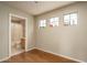 Bedroom with hardwood floors, three windows, and access to an attached bathroom at 23217 N 22Nd Pl, Phoenix, AZ 85024