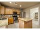 Bright eat-in kitchen with oak cabinets, island, granite countertops, and stainless steel appliances at 23217 N 22Nd Pl, Phoenix, AZ 85024