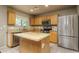 Beautiful eat-in kitchen with oak cabinets, island, granite countertops, and stainless steel appliances at 23217 N 22Nd Pl, Phoenix, AZ 85024