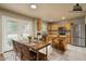 Eat-in kitchen with stainless appliances, wood cabinets, granite counters, an island, and a large dining table at 23217 N 22Nd Pl, Phoenix, AZ 85024