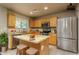 Modern kitchen featuring stainless steel appliances, wood cabinets, granite counters, and a center island at 23217 N 22Nd Pl, Phoenix, AZ 85024