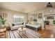Cozy living room featuring bright natural light, neutral paint, couches, and stylish striped rug at 23217 N 22Nd Pl, Phoenix, AZ 85024