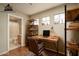 Home office with hardwood floors, industrial shelving and a bathroom at 23217 N 22Nd Pl, Phoenix, AZ 85024