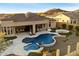 Expansive backyard featuring a pool, spa, fire pit, and covered patio for outdoor entertaining at 2333 N 87Th Pl, Mesa, AZ 85207