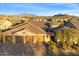 This is an aerial view of a home featuring a three car garage, desert landscaping, and red tile roof at 2333 N 87Th Pl, Mesa, AZ 85207