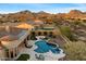 This aerial shot features a stunning pool and spa combination, manicured landscaping, and desert landscaping at 2333 N 87Th Pl, Mesa, AZ 85207