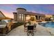 Outdoor kitchen, dining area, pool, and lounge offer premier backyard living at 2333 N 87Th Pl, Mesa, AZ 85207