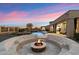 An inviting fire pit area with desert landscaping is joined by a resort-style pool and spa in this lovely backyard at 2333 N 87Th Pl, Mesa, AZ 85207