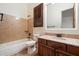 This bathroom has tile walls and flooring, as well as updated fixtures and a wood vanity at 2333 N 87Th Pl, Mesa, AZ 85207