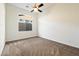This bedroom features neutral colored walls, and carpet, in addition to a window and ceiling fan at 2333 N 87Th Pl, Mesa, AZ 85207