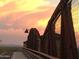 Bridge structure showing the sunset through the metal beams with textured sky at 2333 N 87Th Pl, Mesa, AZ 85207