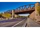 Scenic view of the community bridge with its unique steel structure and stone supports against a blue sky backdrop at 2333 N 87Th Pl, Mesa, AZ 85207