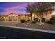 Charming home with three-car garage, stone accents, and mature landscaping at 2333 N 87Th Pl, Mesa, AZ 85207