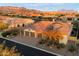 Exterior shot features manicured landscaping, a three car garage, and a paver driveway at 2333 N 87Th Pl, Mesa, AZ 85207