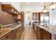Gourmet kitchen with granite countertops, stainless steel appliances, custom cabinetry, and eat-in island at 2333 N 87Th Pl, Mesa, AZ 85207