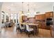 Spacious kitchen featuring a large island, seating, stainless appliances, and adjacent breakfast nook with large windows at 2333 N 87Th Pl, Mesa, AZ 85207