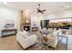 Bright living room featuring a stone fireplace, comfortable seating, and sliding glass doors to the pool at 2333 N 87Th Pl, Mesa, AZ 85207