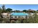 Community pool with lush landscaping and lounge chairs behind a wrought iron fence at 2333 N 87Th Pl, Mesa, AZ 85207