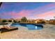An amazing pool and spa combination is surrounded by desert landscaping, outdoor seating, and lush green foliage at 2333 N 87Th Pl, Mesa, AZ 85207