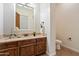 The powder room features a stone countertop vanity with a vessel sink and tiled flooring at 2333 N 87Th Pl, Mesa, AZ 85207