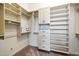 Organized walk-in closet with built-in shelving, drawers, and hanging rods, providing ample storage space at 2333 N 87Th Pl, Mesa, AZ 85207