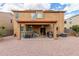 A large backyard has an outdoor dining area beneath a covered patio at 24805 W Vista Norte St, Buckeye, AZ 85326