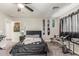 Bedroom displaying a black upholstered bed, skateboard decorations, carpet, and an outside view at 24805 W Vista Norte St, Buckeye, AZ 85326