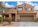 Inviting two-story home boasting a tile roof, two-car garage, and a beautifully landscaped front yard at 24805 W Vista Norte St, Buckeye, AZ 85326