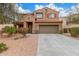Inviting two-story home boasting a tile roof, two-car garage, and a beautifully landscaped front yard at 24805 W Vista Norte St, Buckeye, AZ 85326
