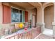 Charming covered front porch with seating offering a welcoming spot to relax at 24805 W Vista Norte St, Buckeye, AZ 85326