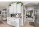 Open kitchen with white cabinets, tiled floors, and a view of the living area at 24805 W Vista Norte St, Buckeye, AZ 85326