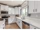 Modern kitchen featuring white cabinets, quartz countertops, and stainless steel appliances at 24805 W Vista Norte St, Buckeye, AZ 85326