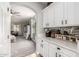 Bright kitchen with white cabinets, quartz countertops, and coffee bar at 24805 W Vista Norte St, Buckeye, AZ 85326