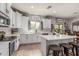 Well-lit kitchen features white cabinets, stainless appliances, and a center island at 24805 W Vista Norte St, Buckeye, AZ 85326