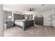 Spacious main bedroom featuring gray wood furniture set, carpeted floor, and ceiling fan at 24805 W Vista Norte St, Buckeye, AZ 85326