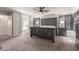 View of the main bedroom showcasing stylish wood furniture, carpeted floor, and ensuite bathroom at 24805 W Vista Norte St, Buckeye, AZ 85326