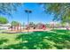 Well-maintained playground featuring various play structures, safety surfacing, and ample green space at 24805 W Vista Norte St, Buckeye, AZ 85326