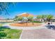 Community playground with shade structure, swings, and recreational equipment surrounded by landscaping at 24805 W Vista Norte St, Buckeye, AZ 85326