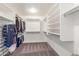 Walk-in closet with organized shelving, rods, and carpeted floor, perfect for storage at 24805 W Vista Norte St, Buckeye, AZ 85326