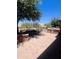 Backyard featuring a built-in barbecue, tiled patio, and desert landscaping at 26336 W Tina Ln, Buckeye, AZ 85396
