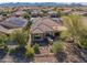 Aerial view of a well-maintained backyard with desert landscaping, covered patio, and beautiful mountain views at 26336 W Tina Ln, Buckeye, AZ 85396
